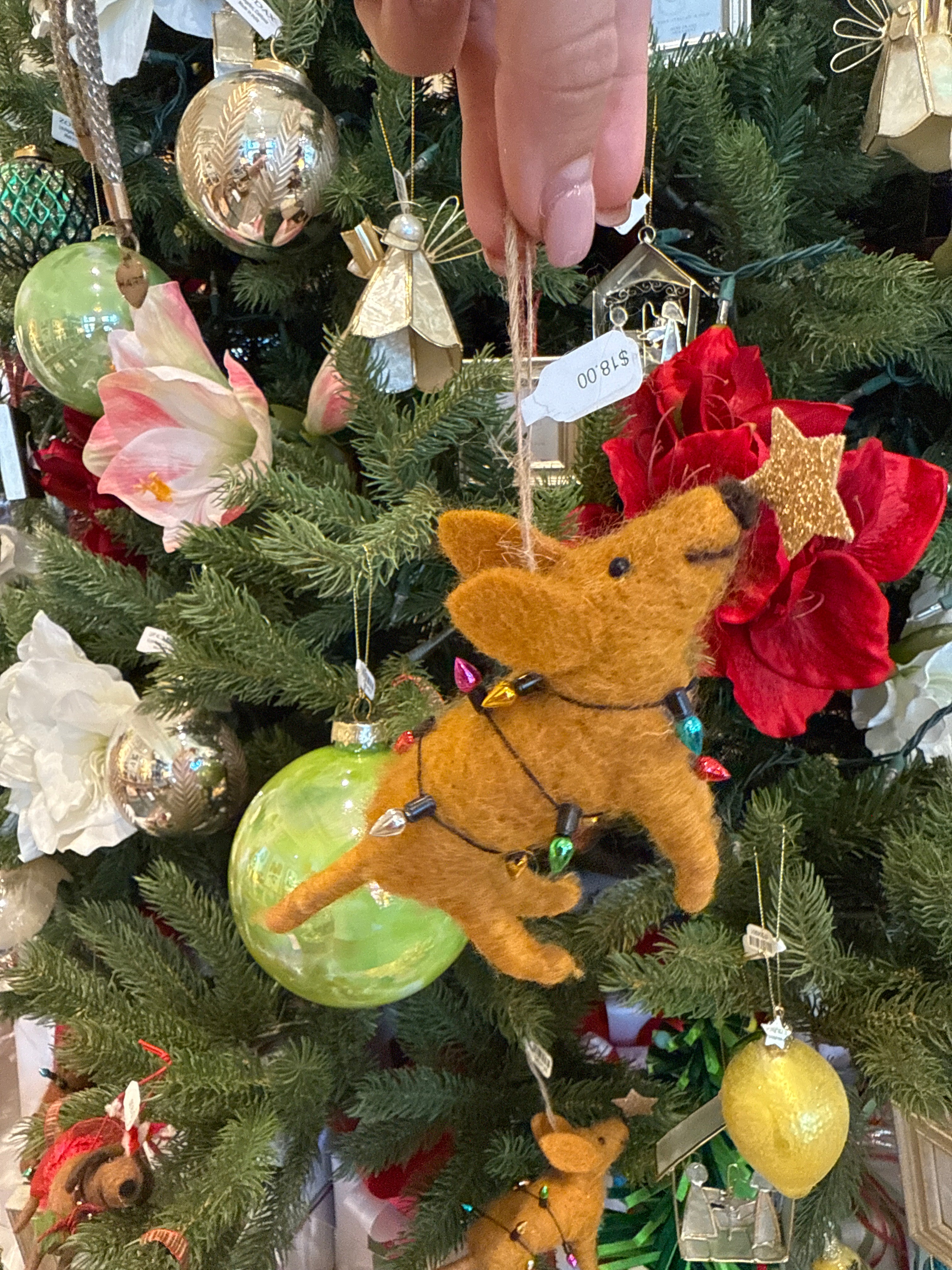 tan felt dog ornament wrapped in light with a star